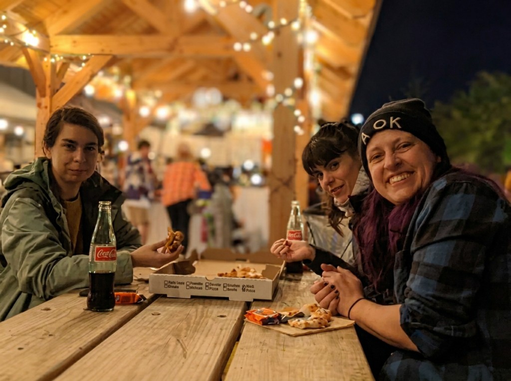Friends gathered for an evening meal under the Highland Park Pavilion